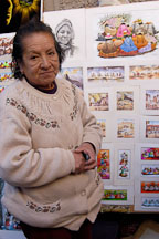 Woman selling prints Pisac market, Sacred Valley, Peru. - Photo #9082