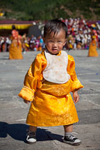 Toddler walking in the courtyard at Thimphu tsechu festival. - Photo #22690