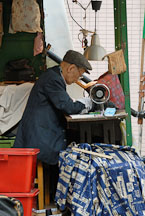 Tailor working on his sewing machine. Pottinger street, Hong Kong, China. - Photo #16396
