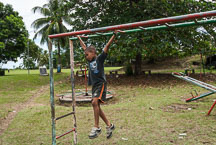 Boy hanging from bars. Tortuguero village, Costa Rica. - Photo #13999