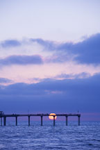 Setting sun just over the horizon at Ocean beach pier. San Diego, California. - Photo #26199