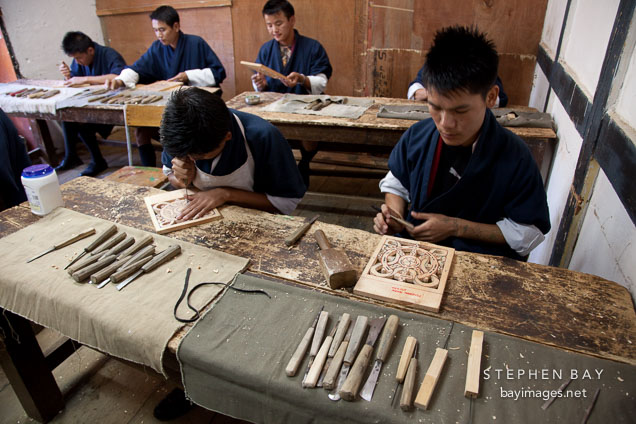 Young male students in the wood carving classroom. National Institute for Zorig Chusum, Thimphu, Bhutan.