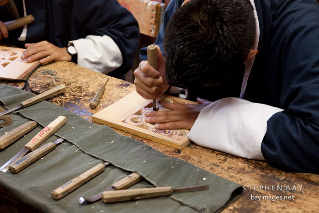Carving an intricate design on a wood block. National Institute for Zorig Chusum, Thimphu, Bhutan.