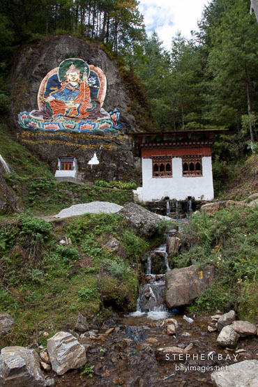 Painting of Guru Rinpoche and small stream. Road from Thimphu to Punakha, Bhutan.