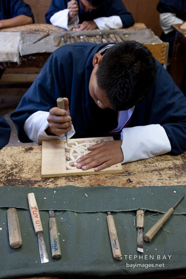 Student carving wood block at the National Institute for Zorig Chusum. Thimphu, Bhutan.