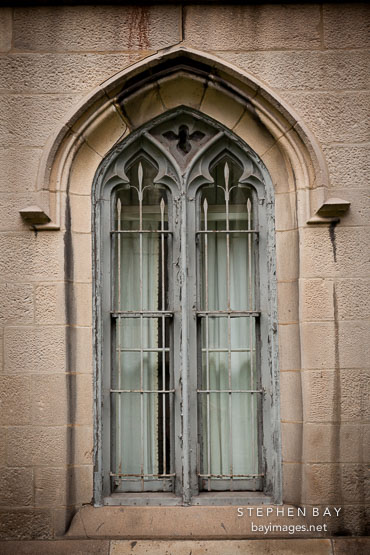 Arched window with bars. Grace Church. New York.