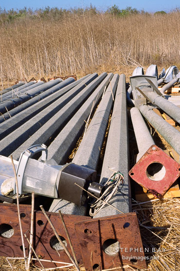 Abandoned street posts lying in a field. Irvine, California, USA.