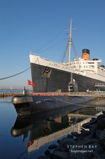 Queen Mary cruise ship and Russian submarine reflected in the water. Long Beach, California, USA.