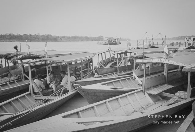 Boatmen playing cards. Puerto Maldonado, Peru.
