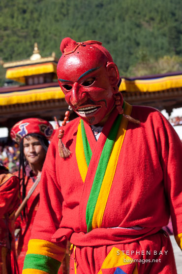 Clown (atsara) wearing bright red mask. Thimphu tsechu, Bhutan.