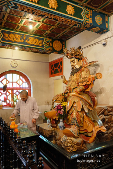 Monk making offering. Po Lin Monastery, Hong Kong.