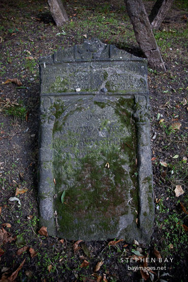 Fallen moss covered gravestone in the Old Jewish Cemetery. Prague, Czech Republic.