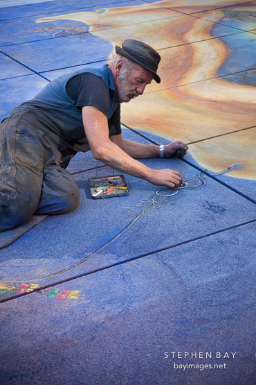 Artist drawing mural. Paris, France.