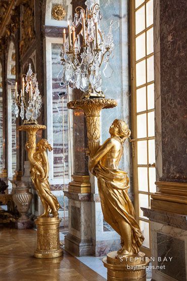 Gilded sculpted gueridons at the Hall of Mirrors. Versailles, France.