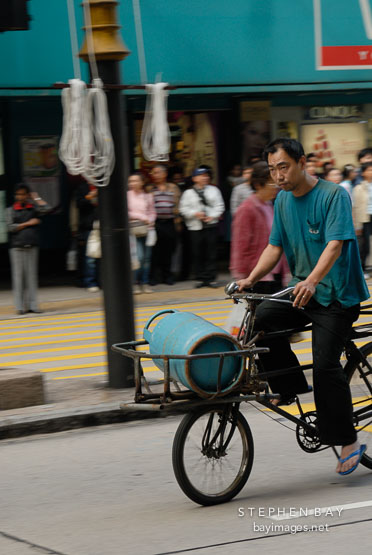 Bicycling with propane. Nathan road, Hong Kong, China.