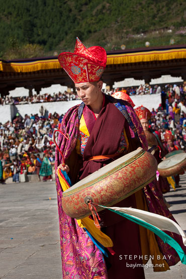 Monk wearing cloak and elaborate robes. Thimphu tsechu, Bhutan.
