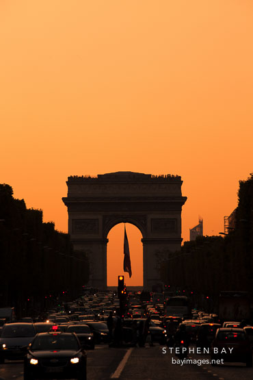 Red light at sunset on the Arc de Triomphe. Paris, France.