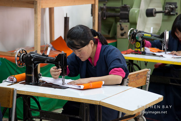 Student using sewing machine at the National Institute for Zorig Chusum. Thimphu, Bhutan.