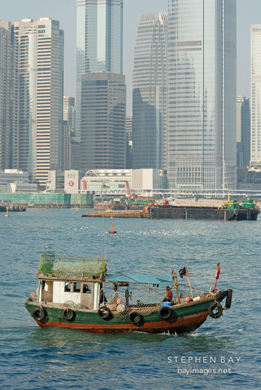 Small fishing boat in Victoria Harbor. Hong Kong, China.