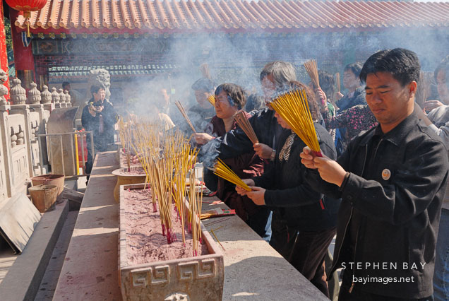 Worshippers at the Wong Tai Sin Temple. Hong Kong, China.