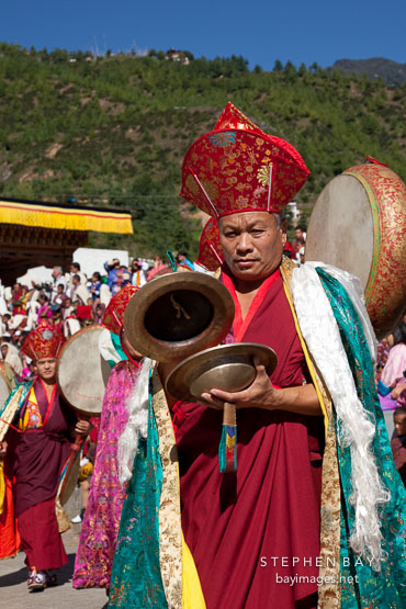 Monk using cymbals in the morning procession at Thimphu tsechu, Bhutan.