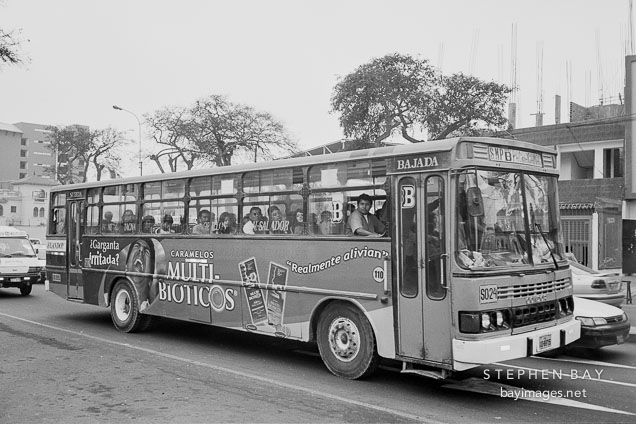 Peruvians taking the bus in Miraflores. Lima, Peru.