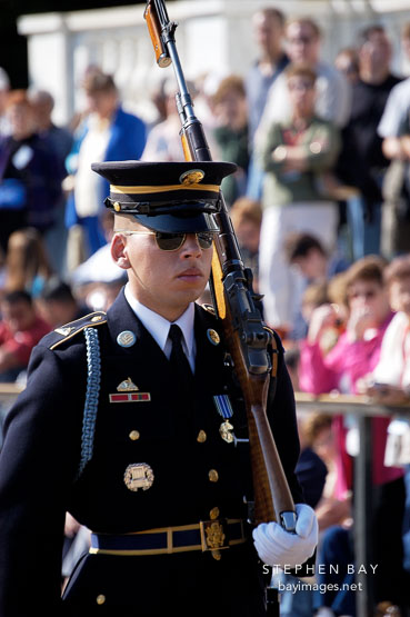 Soldier marching with rifle at the Tomb of the Unknowns, Arlington National Cemetery. Arlington, Virginia, USA.
