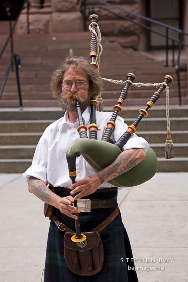 Musician playing bagpipes. Toronto, Canada.