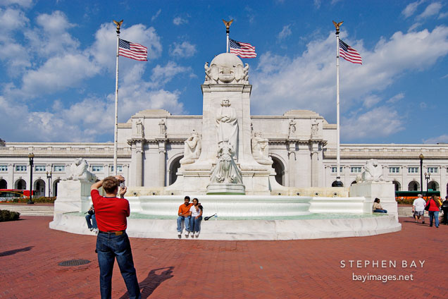 Tourists taking photographs at the Christopher Columbus Memorial Fountain. Union Station, Washington, D.C., USA.