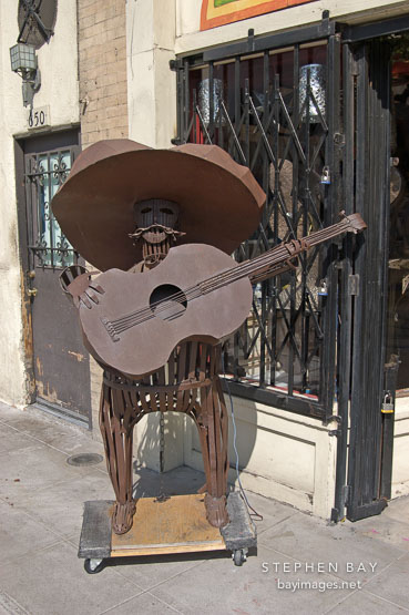 Iron sculpture of man playing the guitar. El Pueblo de la Reina  de los Angeles. Los Angeles, California, USA.