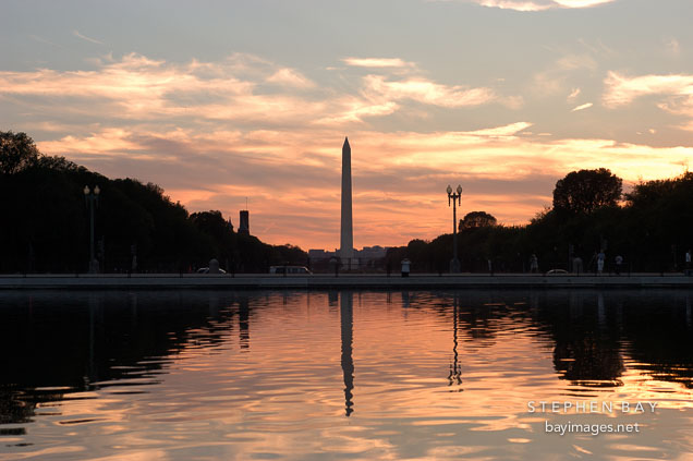The Capitol reflecting pool at sunset with a bright orange glow. Washington, D.C.