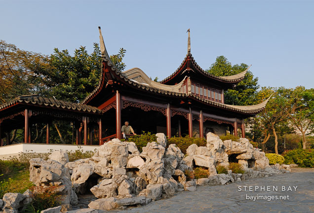 Two-storey Mountain View Pavilion with limestone rocks in front. Kowloon walled city park. Hong Kong.