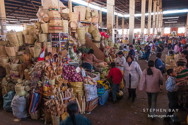 Market stall selling produce and baskets. Central market, Cusco, Peru.