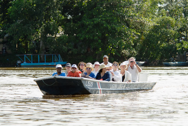 Tourists in Tortuguero watching wildlife from a boat. Costa Rica.