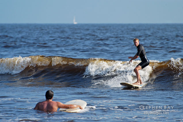 Surfer riding a wave. Venice, California, USA.