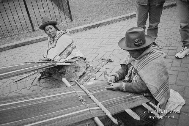 Women weaving cloth on a traditional loom. Miraflores, Lima, Peru.
