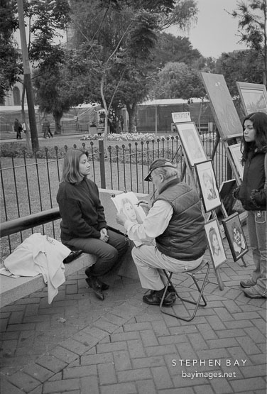 Artist making a sketch of a young woman. Miraflores, Peru.