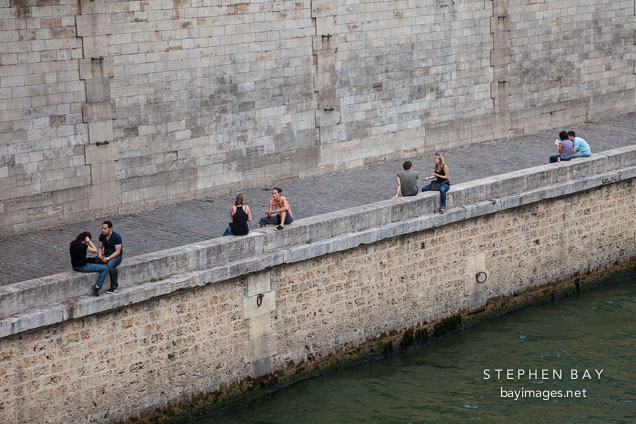 Sitting along the Seine river. Paris, France.