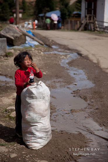 Boy with sack of produce. Phobjikha Valley, Bhutan.