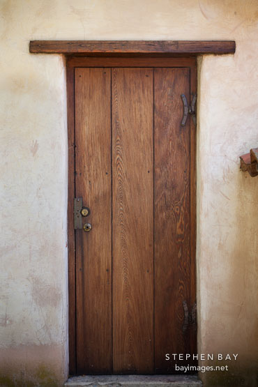 Narrow wooden door. Carmel Mission, California.