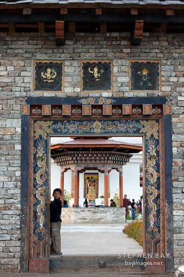 Boy standing in the entrance to the National Memorial Chorten. Thimphu, Bhutan.