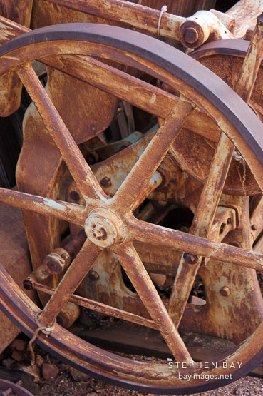 Rusted wheel on a Chandler & Price New Series press. Goldfield, Phoenix, Arizona, USA.