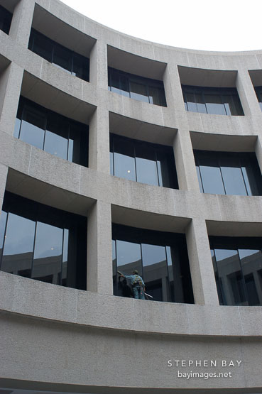 Worker washing windows at the Hirshhorn musem. Washington, D.C.
