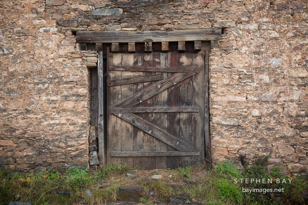 Large door on the wall of the main tower on Drukgyal Dzong. Paro, Bhutan.