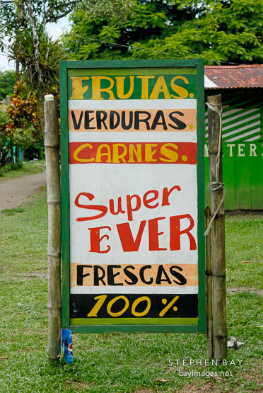 Supermarket sign in Spanish. Fruits, vegetables, and meats. Tortuguero village, Costa Rica.