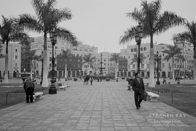 Man in suit walking through Plaza Mayor in Lima, Peru.