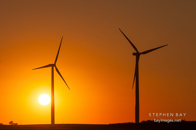 Two wind turbines at sunset. Story County, Iowa.