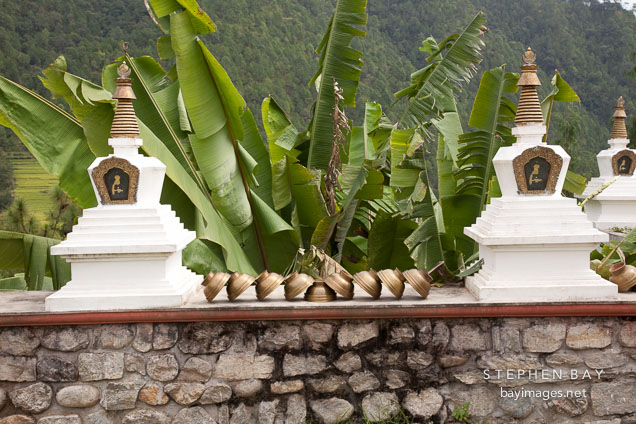 Brass bowls between two mini-chorten. Khamsum Yuelley Namgyal Chorten, Punakha Valley, Bhutan.