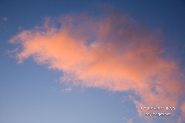 Cloud with orange and pink glow at sunset. Mission Peak, Fremont, California.