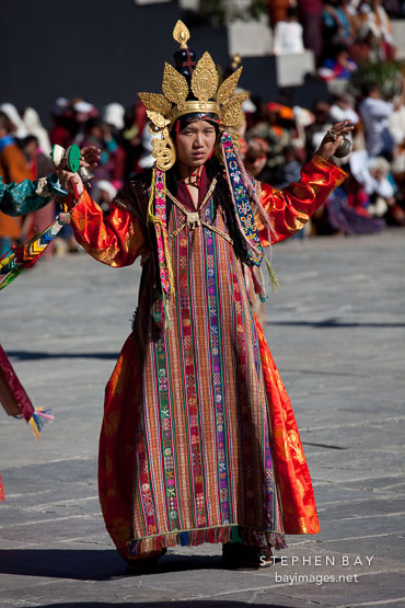 Gold crown and long brocade dress on dancer. Thimphu tsechu, Bhutan.